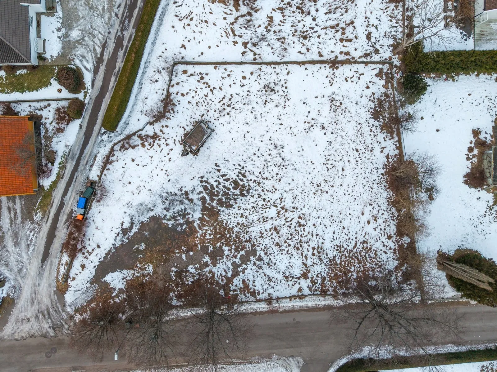 Raw site prospect with snow and uneven terrain